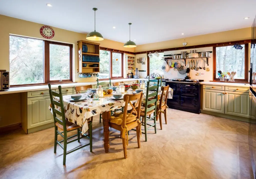 a kitchen with a dining room table and chairs at Wee Wilds in Newtonmore