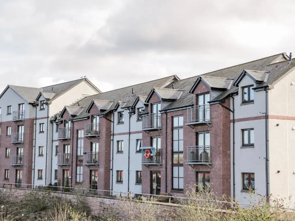 a row of apartment buildings at Riverview Apartment in Inverness