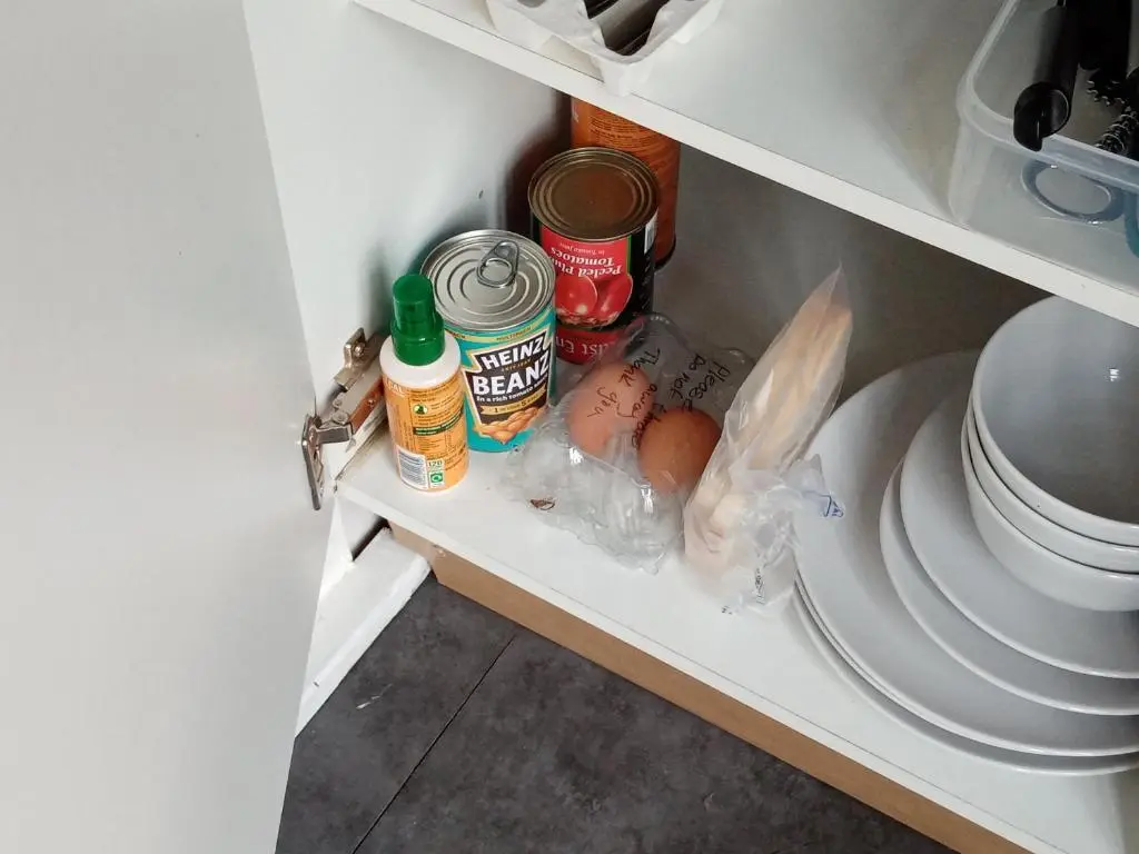 an open refrigerator with food and spices on a shelf at Wee Hoose Glaping Pod 2 in Skail