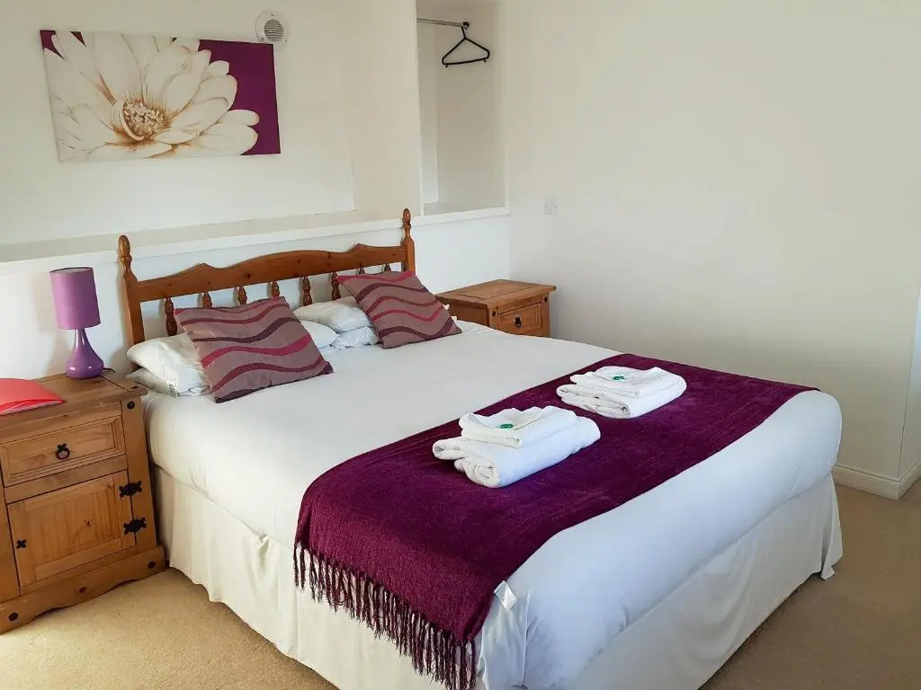 a bedroom with a bed with two towels on it at The Dolphin - Uk31004 in Avoch