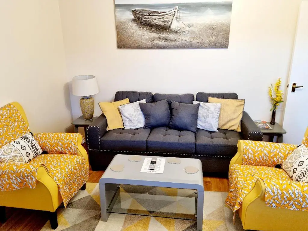 a living room with a couch and two chairs at Inverness City 2 bedroom free parking in Inverness
