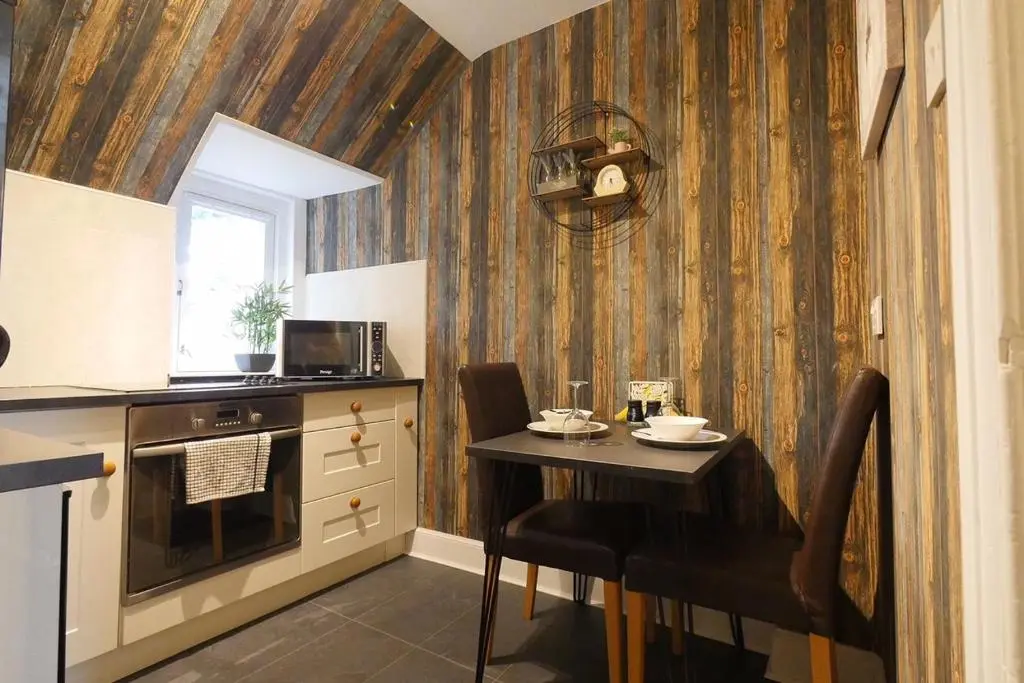 a small kitchen with a table and a counter at Thistle Apartment, Inverness in Inverness