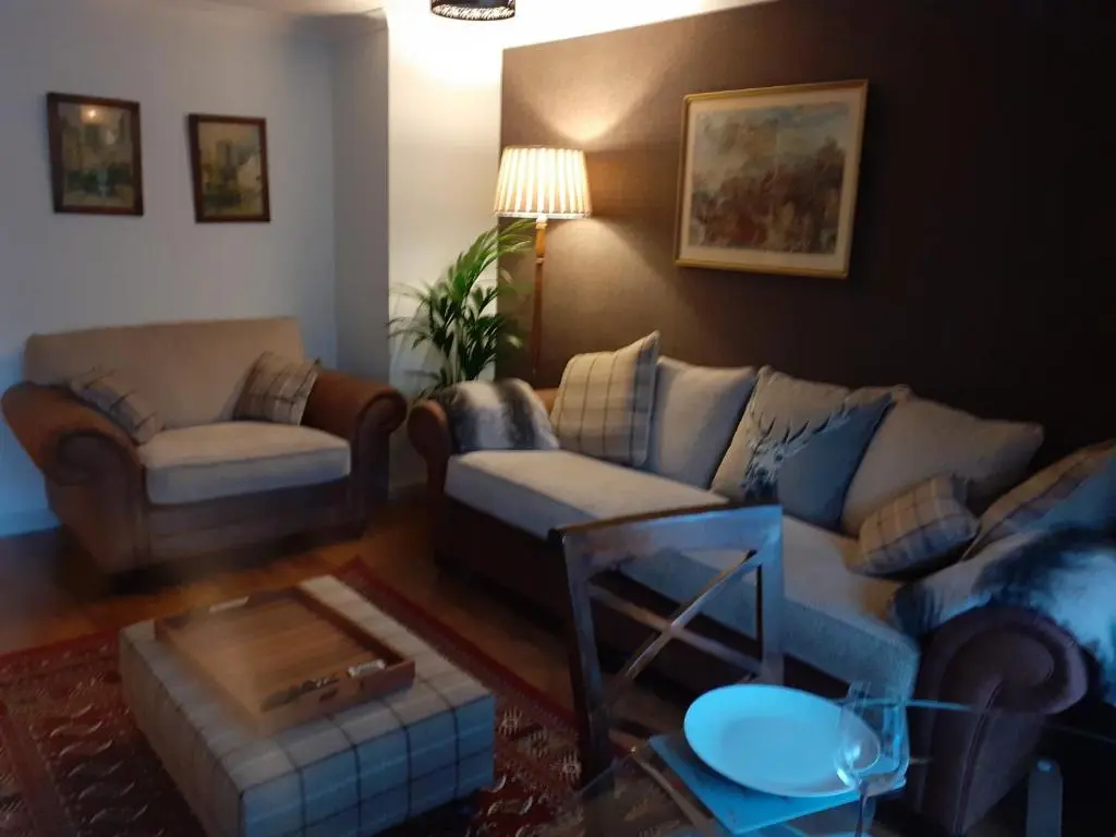 a living room with couches and a coffee table at Bishops Park Apartment in Inverness