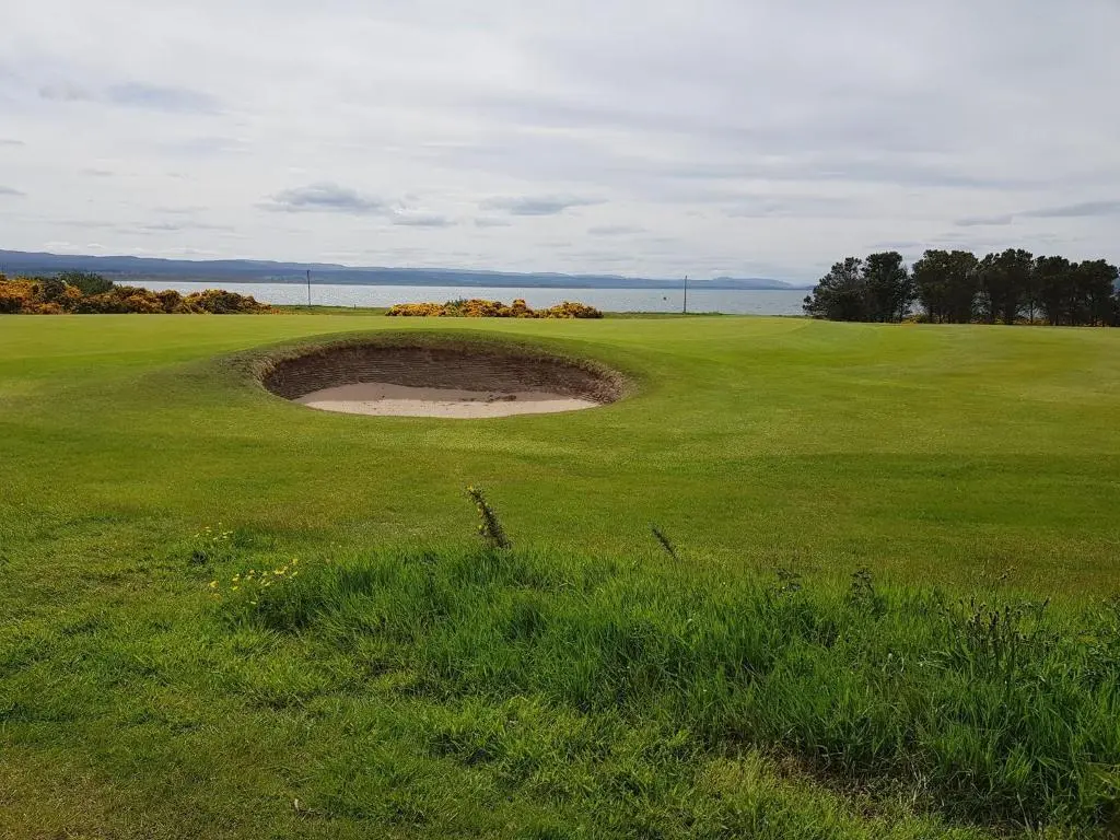 a hole in the middle of a golf green at Pleasant Point Holiday Cottages in Rosemarkie