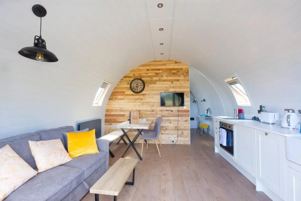 a living room with a couch and a table at North Coast 500 Pods - Brora in Brora