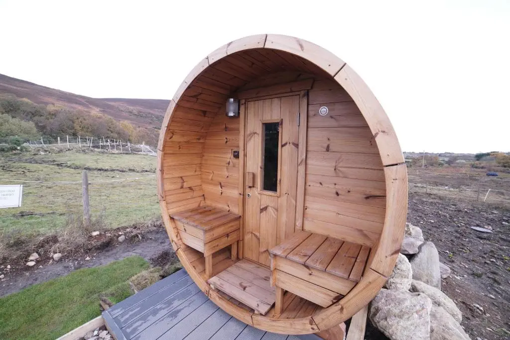 a large wooden sauna with a large wooden door at North Coast 500 Pods - Brora in Brora