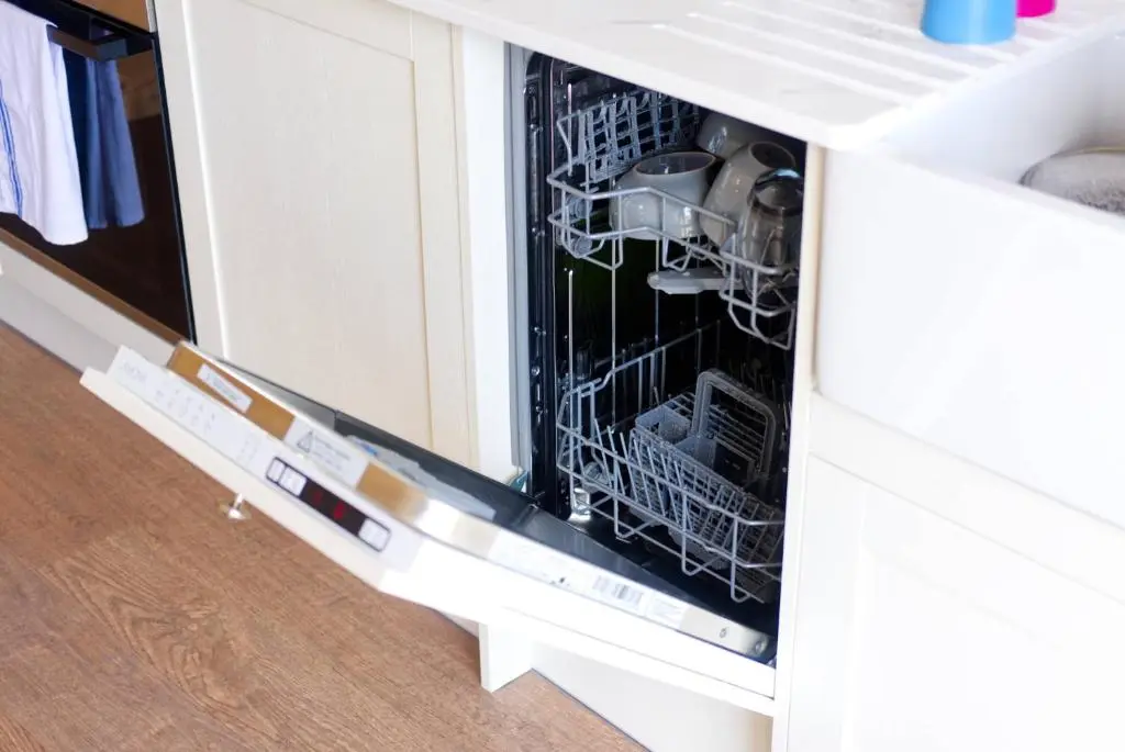 a dishwasher with dishes in it in a cabinet at North Coast 500 Pods - Brora in Brora