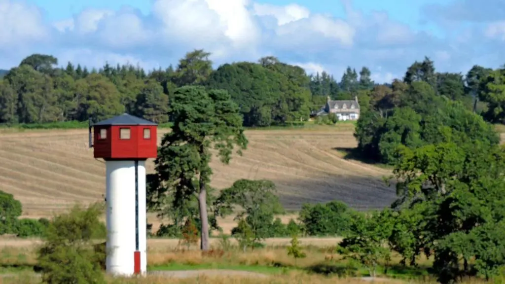 a red and white tower with a bird house on it at Balnagown Estates Peat Cottage in Kildary