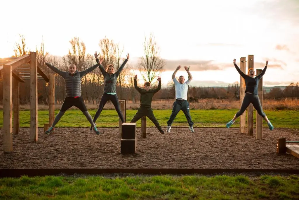 a group of people jumping on a playground at Balnagown Estates Swiss Cottage in Barbaraville