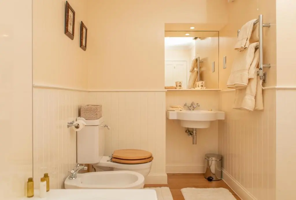 a bathroom with a toilet and a sink at Balnagown Estates Swiss Cottage in Barbaraville