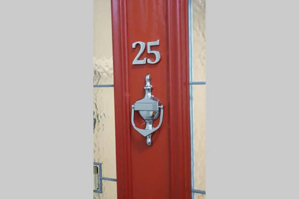 a red door with the number on it at Smart & Stylish Holiday Apartment in the city centre in Inverness