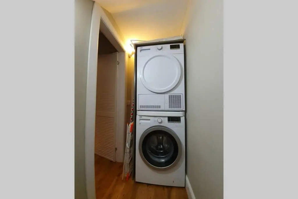a washer and dryer sitting in a hallway at Smart & Stylish Holiday Apartment in the city centre in Inverness