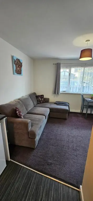 a living room with a couch and a table at Arisaig Flat in Inverness
