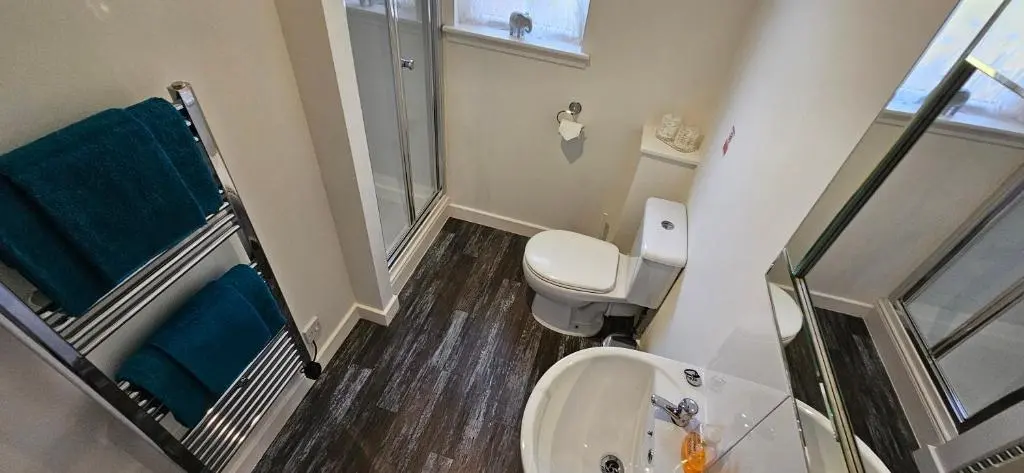 a small bathroom with a toilet and a sink at Arisaig Flat in Inverness