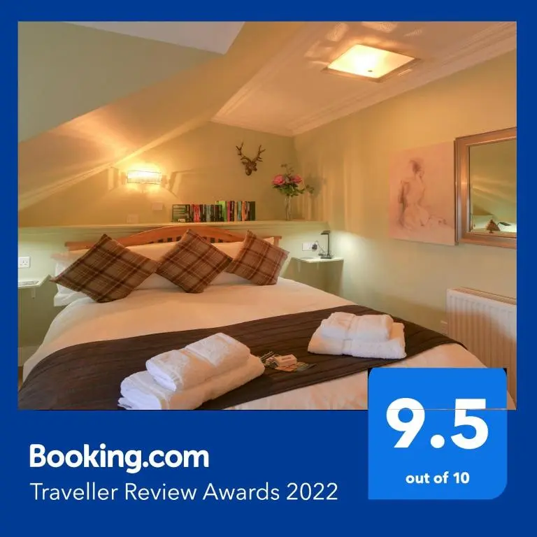 a bedroom with a bed with two towels on it at King Street Apartment in Inverness