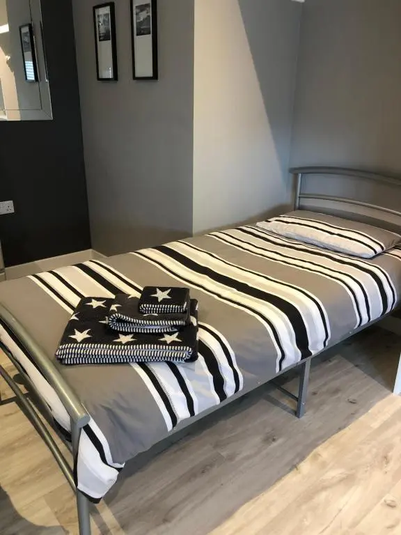a bed with two pillows on it in a room at The Chalet in Inverness