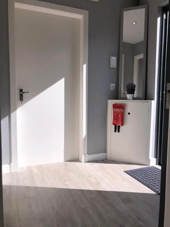 a room with a white door and a table at The Chalet in Inverness