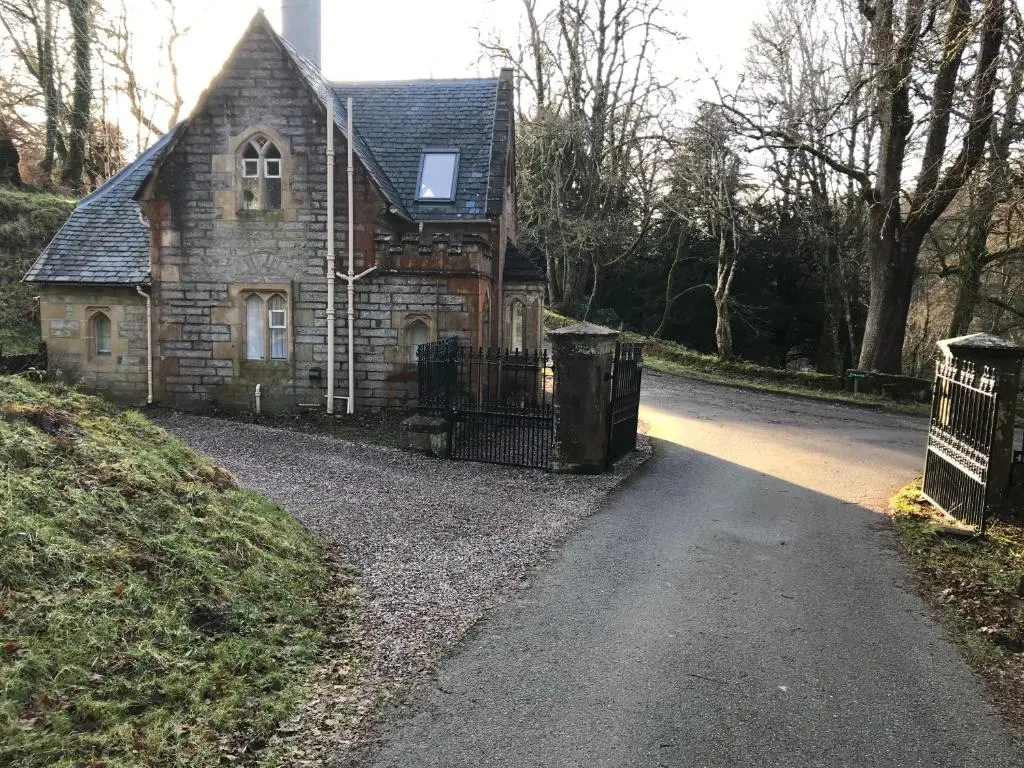 an old stone house on a gravel road at North Lodge in Invergarry