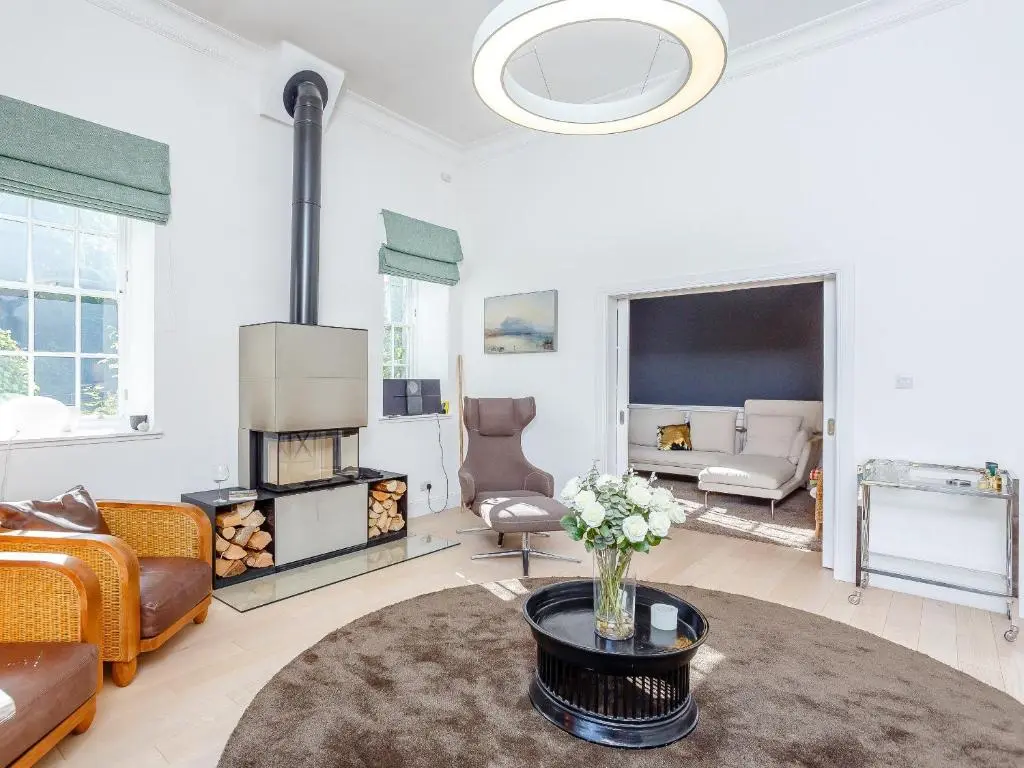 a living room with a vase of flowers on a table at Skene House Court in Dunecht