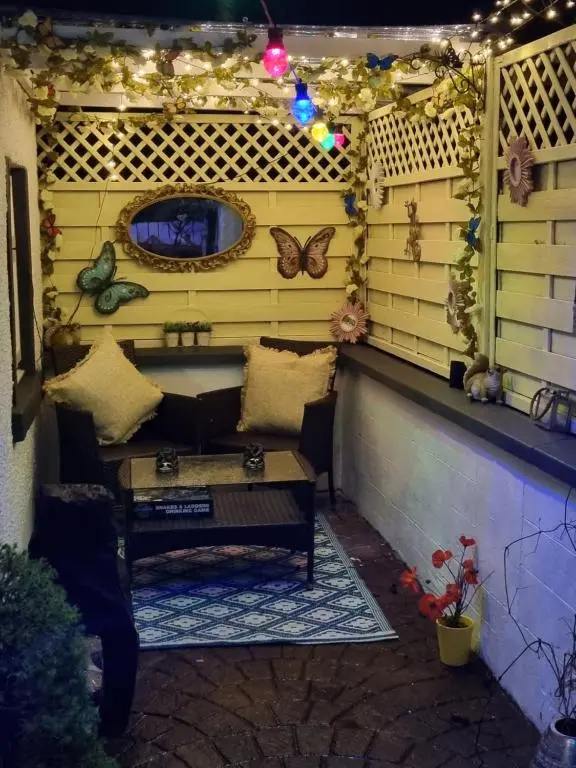 a pergola with a bench and butterflies on it at The little garden hoose in Inverness