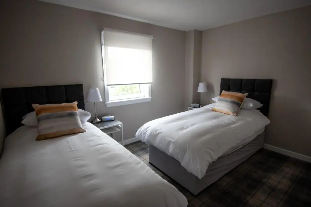 a bedroom with two beds and a window at The View 3-Bed Cottage Findochty Buckie Moray in Findochty