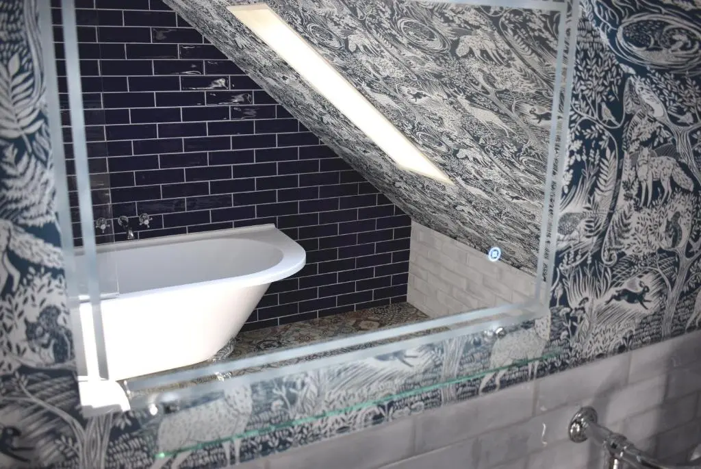 a bathroom with a sink and a black and white tile wall at The Mash Tun in Aberlour