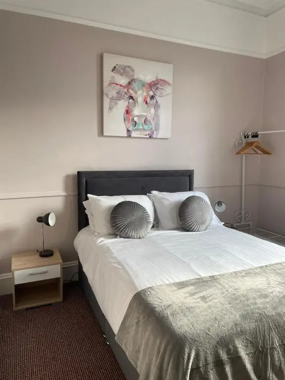 a bedroom with a bed with two pillows on it at The Banks Of Ury in Inverurie