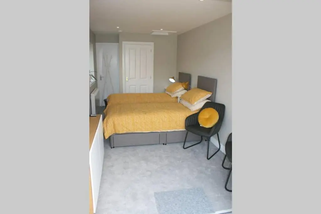a bedroom with a bed and a desk in it at The Snug at the Ski Lodge, Aviemore in Aviemore