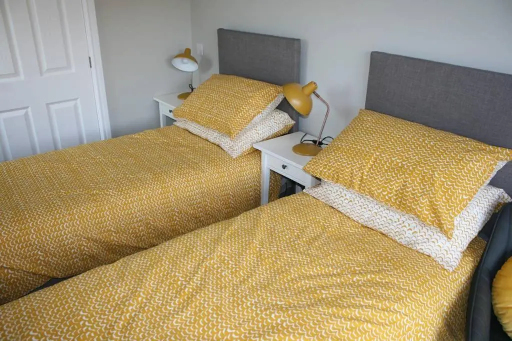 two beds sitting next to each other in a bedroom at The Snug at the Ski Lodge, Aviemore in Aviemore