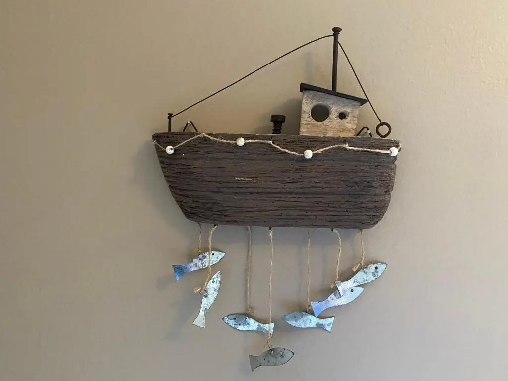 a basket with butterflies hanging on a wall at No. 20 in Inverness