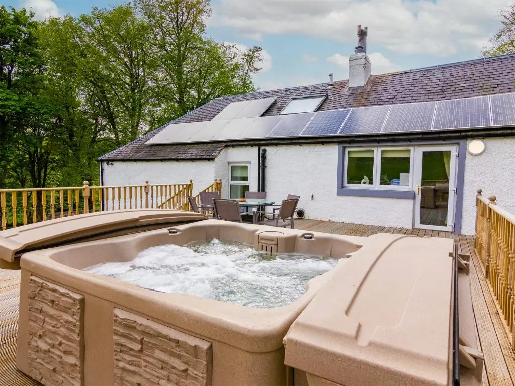 a hot tub on the deck of a house at Keepers Cottage - Uk30246 in Cray