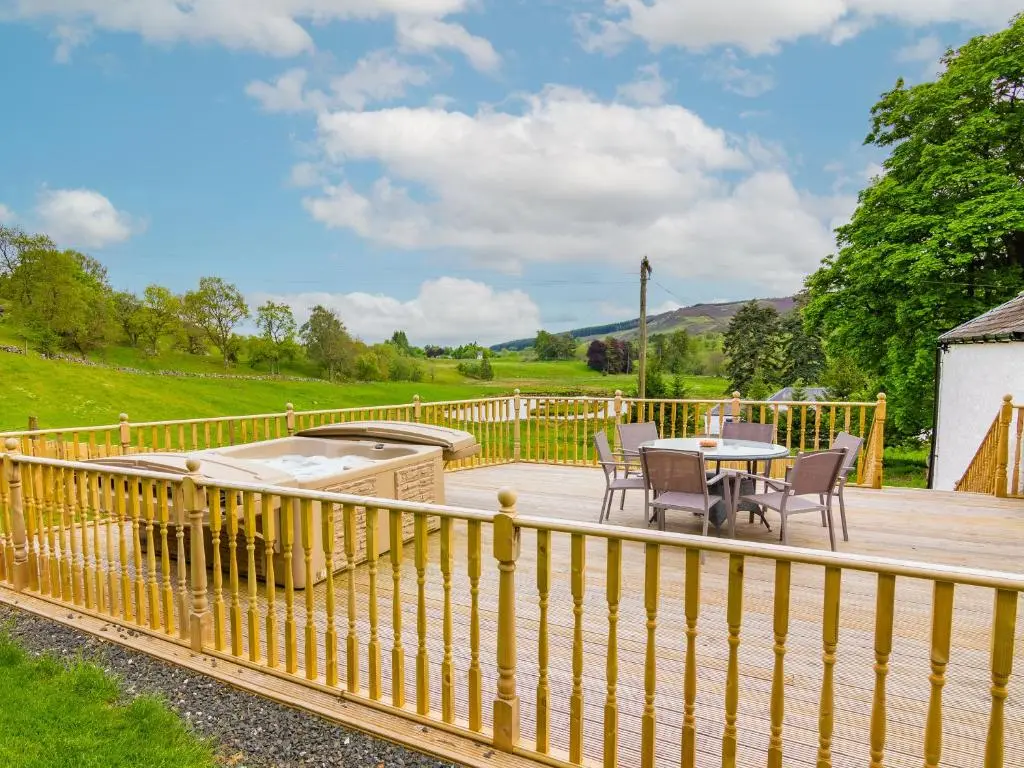 a wooden deck with a table and chairs on it at Keepers Cottage - Uk30246 in Cray