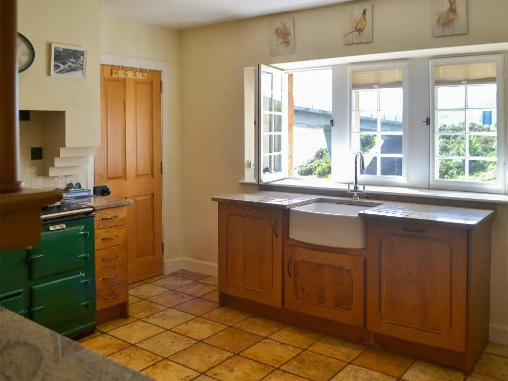 a kitchen with a sink and a window at Sluice Keeper's Cottage in Skelbo