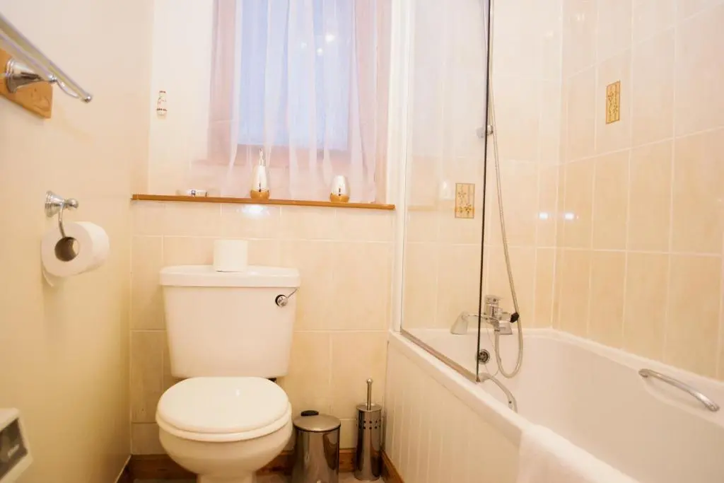 a white bathroom with a toilet and a shower at Superb 2 Bedroom Flat - Refurbished Dec 2024 in Inverness