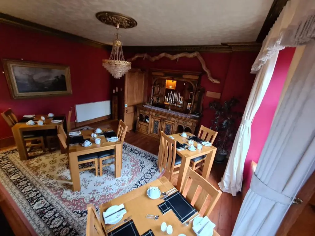 an overhead view of a dining room with tables and chairs at Bluebell House in Inverness