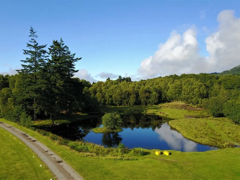 a view of a river with trees and a road at The Apartment at Old Pier House in Fort Augustus