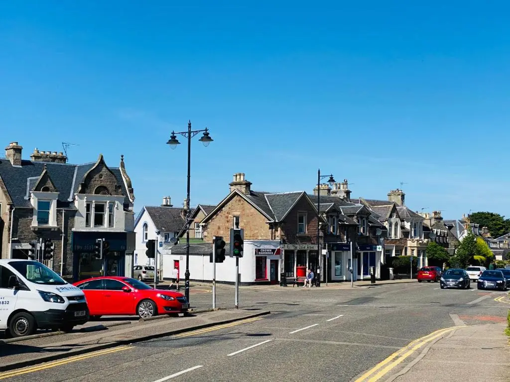 a street with cars parked on the side of the road at Castle Grant Apartment in Inverness