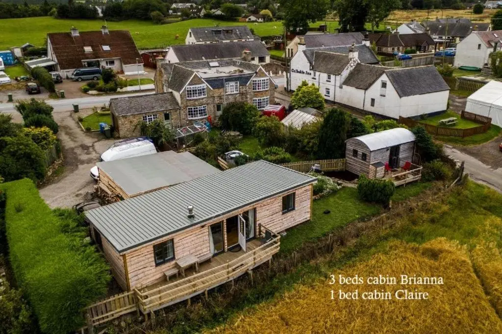 an aerial view of a small town with a house at Culbokie Lodges in Culbokie