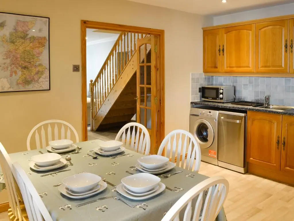 a kitchen and dining room with a table and chairs at East Lewiston in Drumnadrochit
