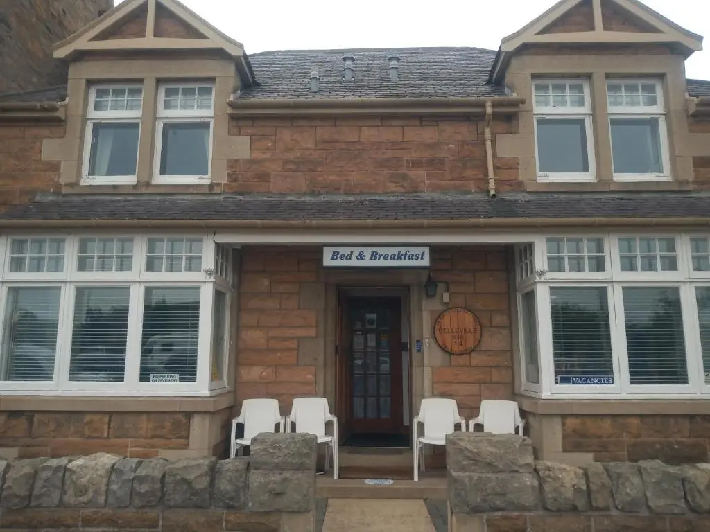 a building with chairs and a sign that reads maid and bartender at BELLEVILLE BED AND BREAKFAST in Elgin