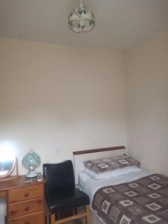 a bedroom with a bed and a desk and a chair at BELLEVILLE BED AND BREAKFAST in Elgin
