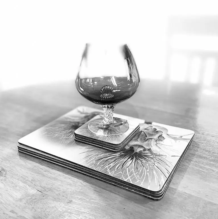 a wine glass sitting on a plate on a table at Dalmore in Nairn