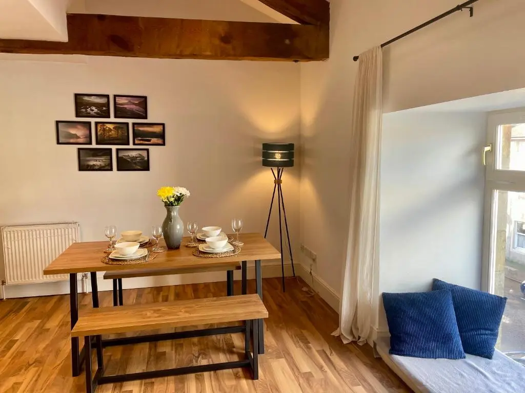 a dining room with a table and a lamp at The Bell Tower in Inverness
