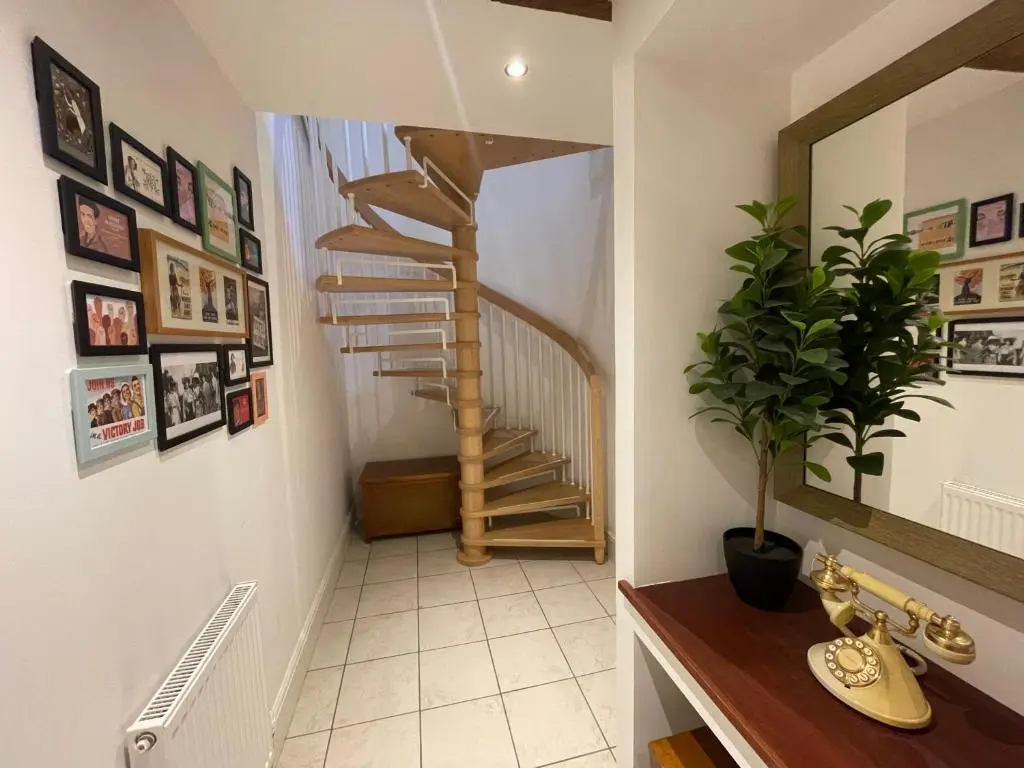 a hallway with a spiral staircase in a home at The Bell Tower in Inverness