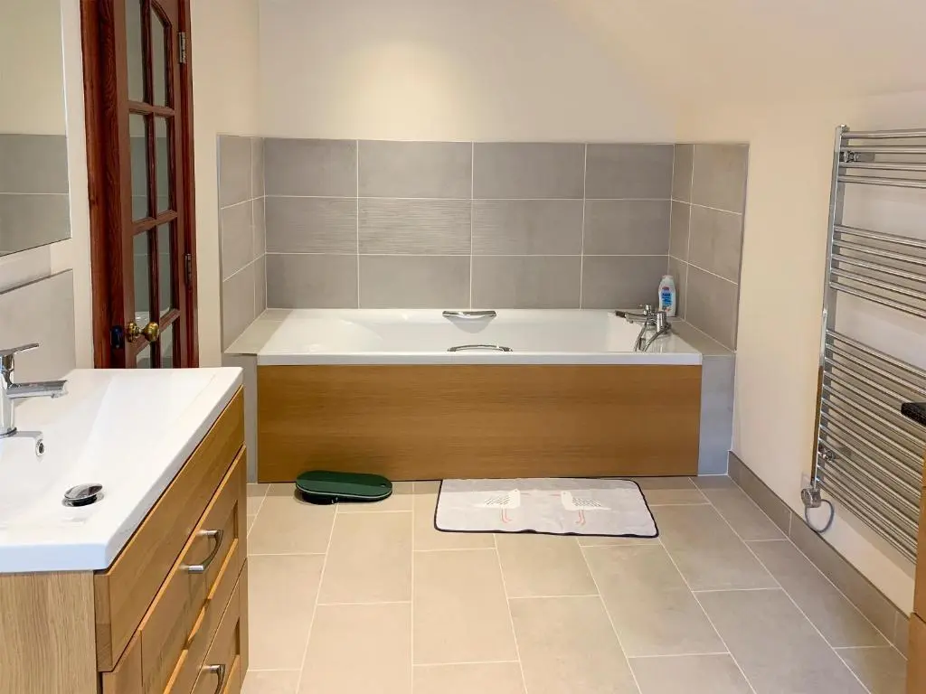 a bathroom with a tub and a sink at The Coyles - Uk31466 in Ballater