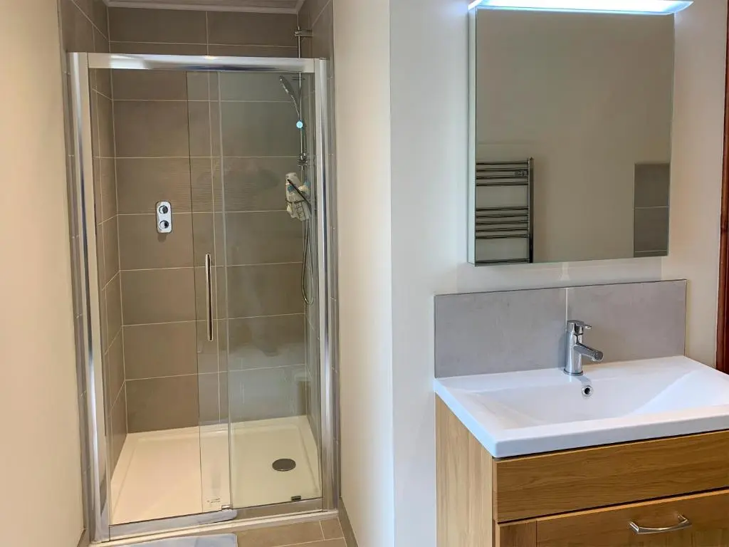 a bathroom with a sink and a shower at The Coyles - Uk31466 in Ballater