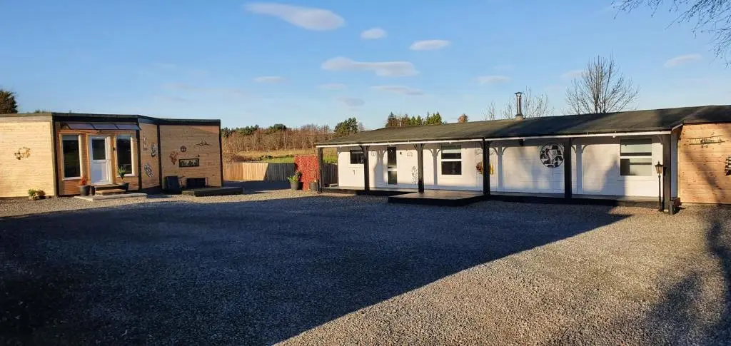 a building with two stalls and a garage at Spacious well equipped Chalet Bungalow close to Nairn, in Auldearn