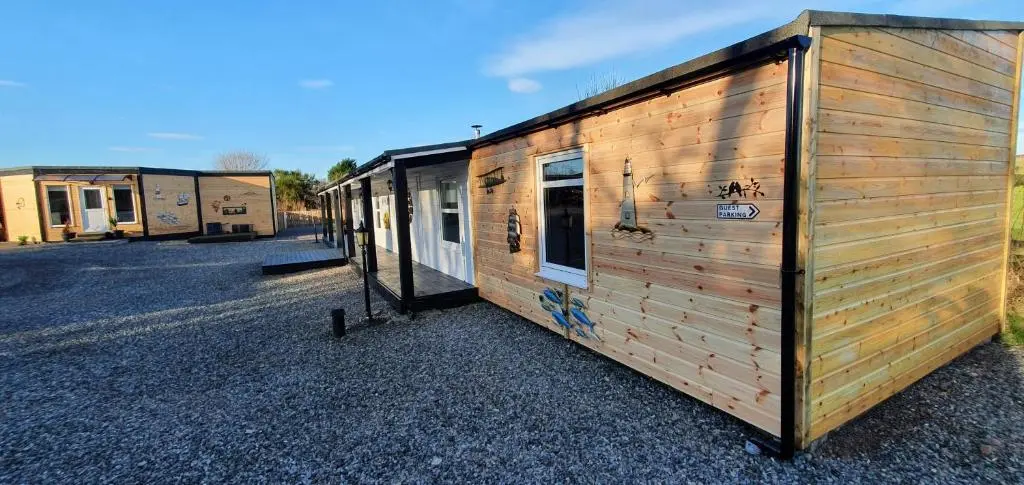 a couple of tiny homes parked in a lot at Spacious well equipped Chalet Bungalow close to Nairn, in Auldearn