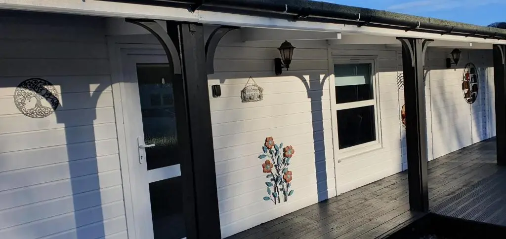 a front porch of a house with a door at Spacious well equipped Chalet Bungalow close to Nairn, in Auldearn