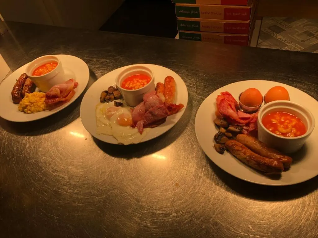 three plates of breakfast food on a table at The Aberdeen Arms Hotel in Tarves